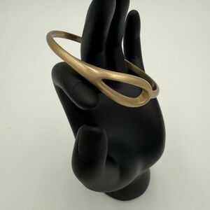 Gold Tone Bangle Bracelet With Open Teardrop Shape